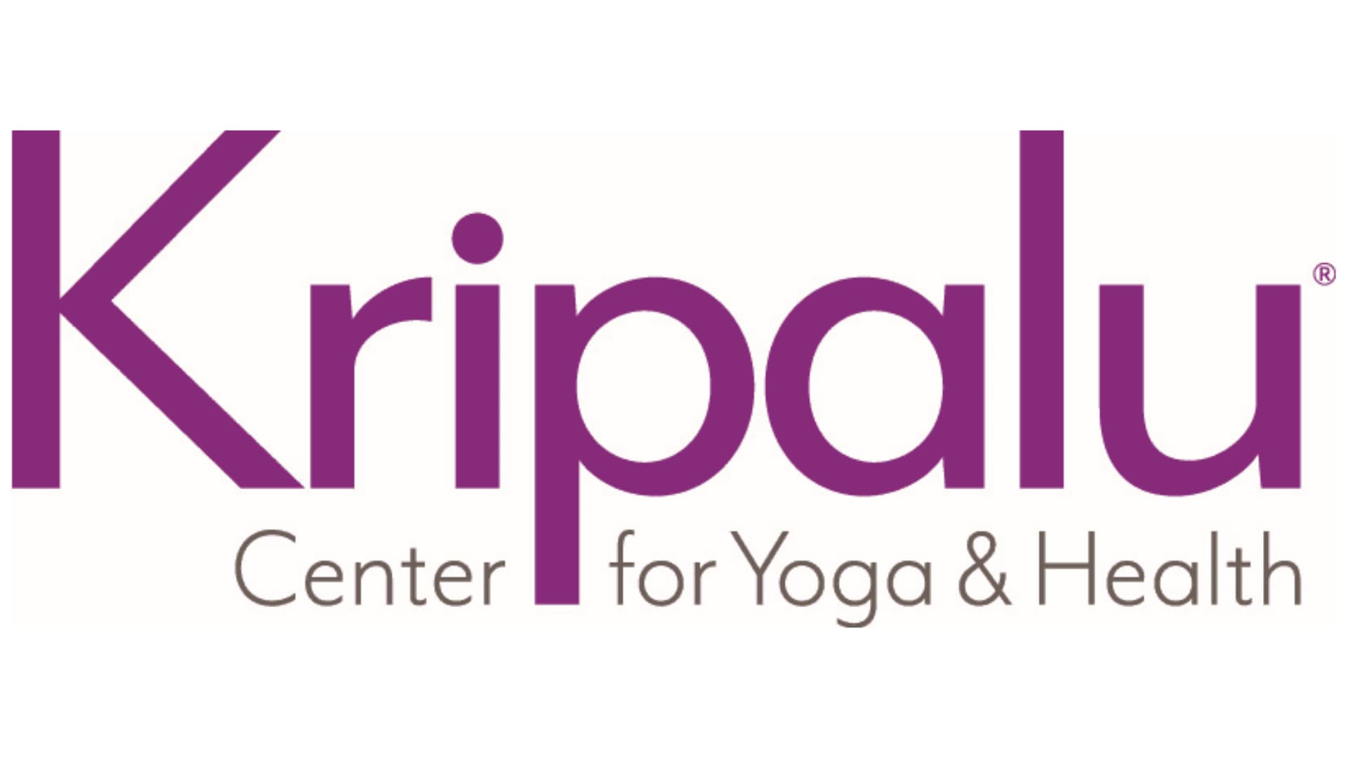 Logo for Kripalu Center for Yoga & Health featuring a large, purple stylized font above smaller text separated by a purple block.